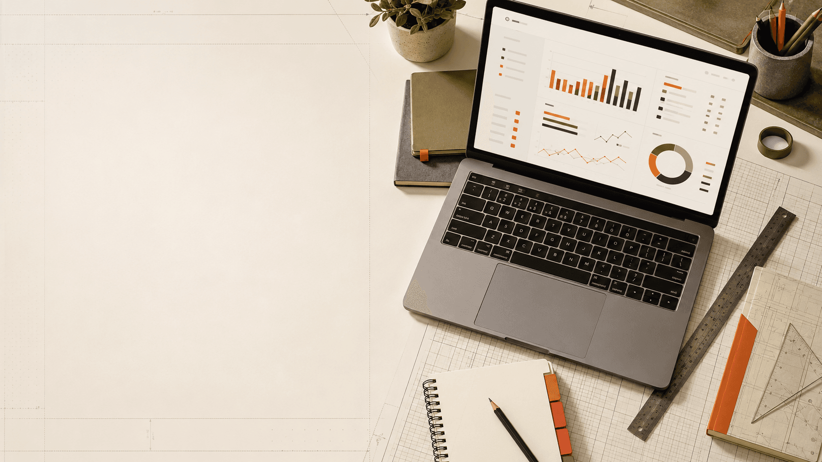 Top-down view of an operator's desk: a laptop showing a campaign dashboard beside notebooks and a pencil.